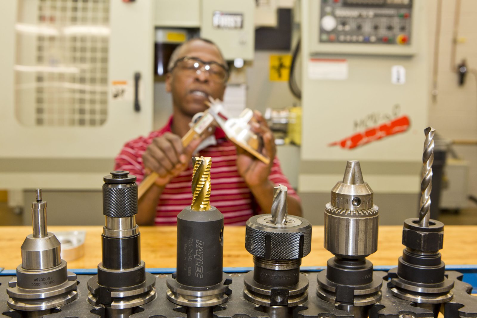 Machinist with precision cutting tools on the shop floor
